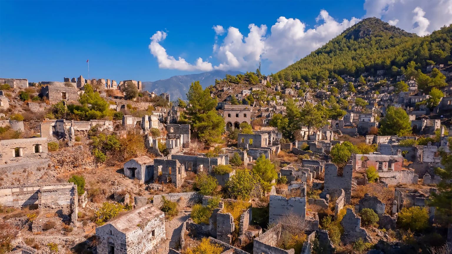 The abandoned stone houses and churches of the historic Kayaköy near Fethiye. A sad and authentic Greek village, witness to the population exchange, now visited as a museum village.