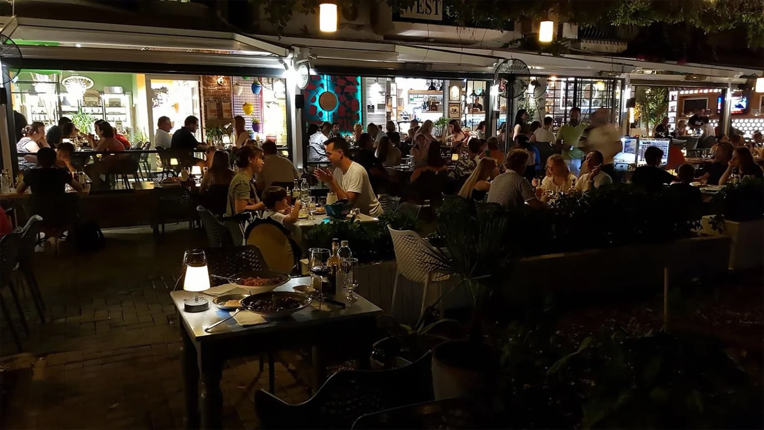 The friendly atmosphere of West Cafe, one of the popular meeting points in Gocek. A vibrant venue near the marina, known for its breakfast, coffee, and delicious food.