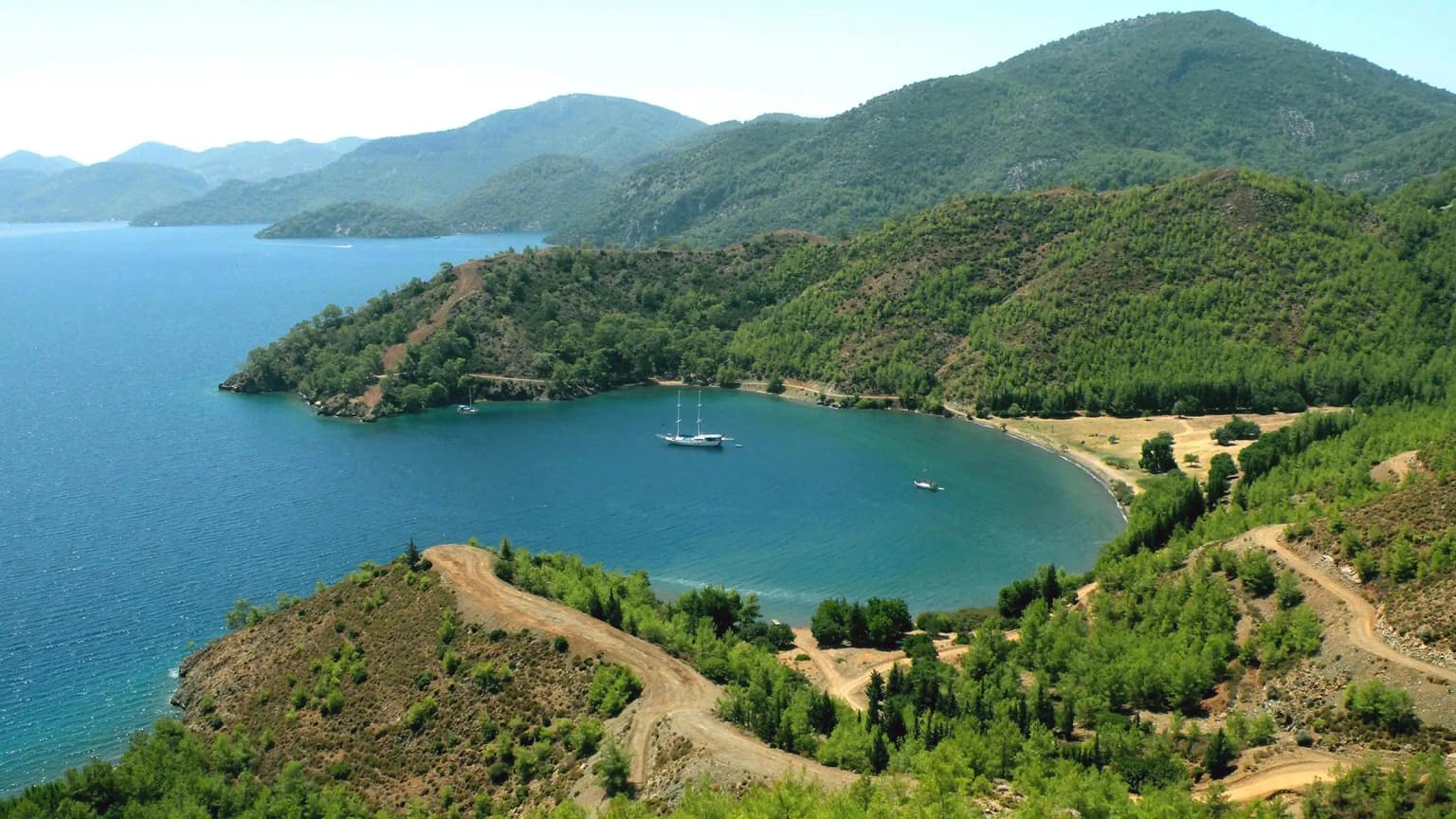 The wide beach and sea surrounded by pine trees of Kille Bay in Gocek. A popular swimming and break spot accessible by both land and sea.